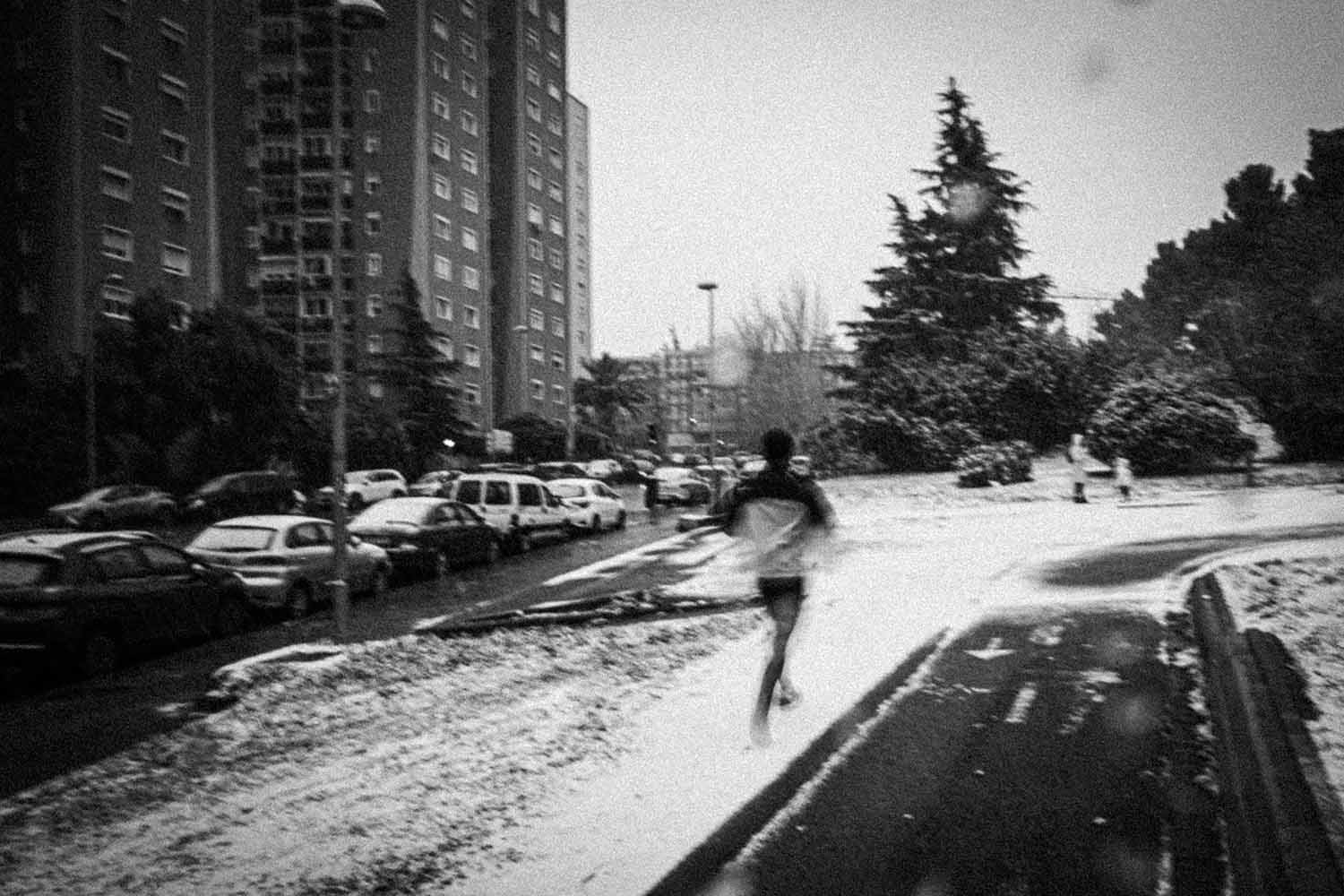 a person running on a snowy sidewalk